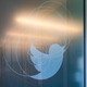 The Twitter logo of a blue bird on the window of the Los Angeles corporate offices.